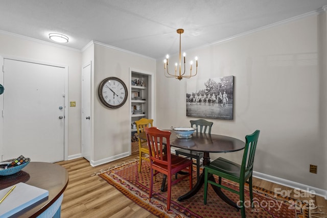 2503 Roswell Ave Unit 208, Charlotte, NC 28209 - dining space featuring light wood-type flooring, a chandelier, and crown molding