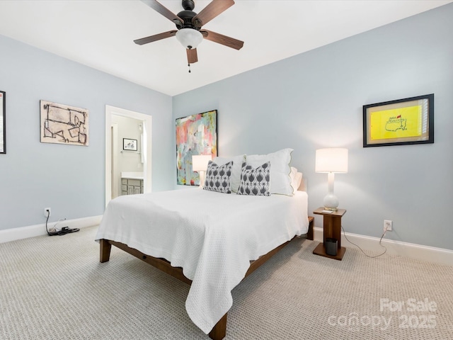 carpeted bedroom with baseboards, ceiling fan, and ensuite bath