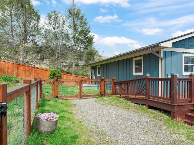 view of yard with fence, a gate, and a wooden deck