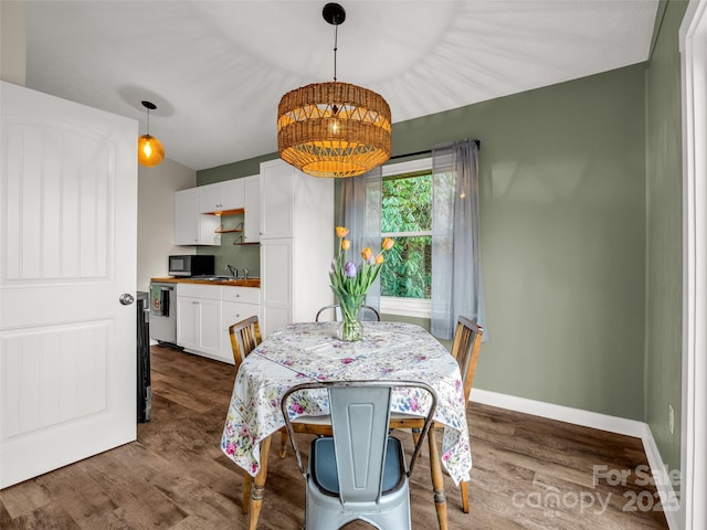 dining room featuring baseboards and dark wood finished floors
