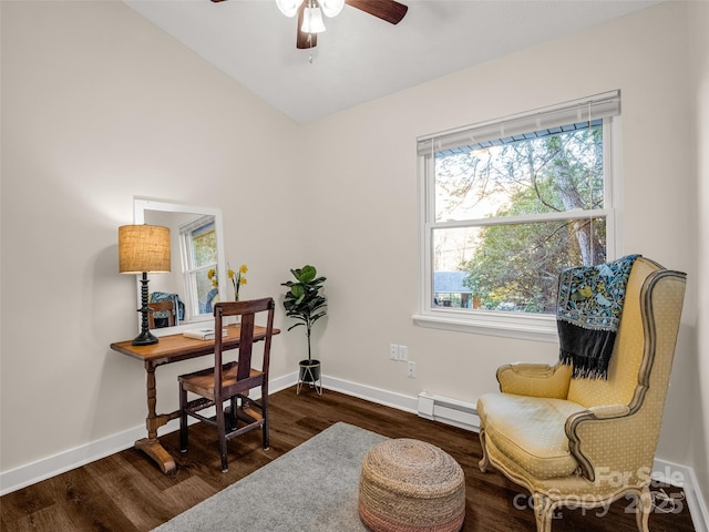 office space featuring vaulted ceiling, dark wood-type flooring, baseboards, a baseboard radiator, and a ceiling fan