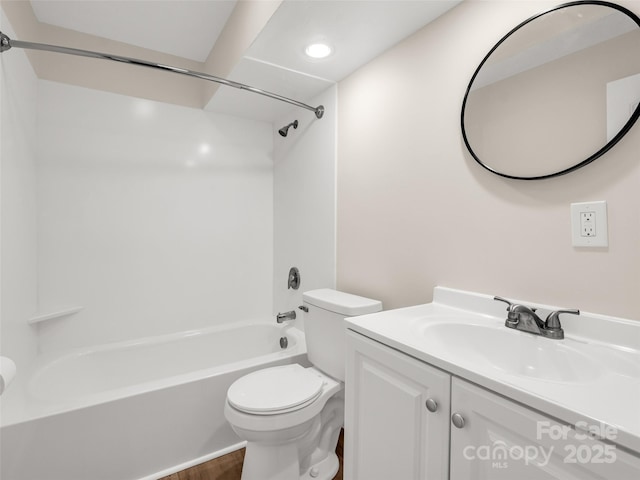 bathroom with bathtub / shower combination, toilet, and vanity