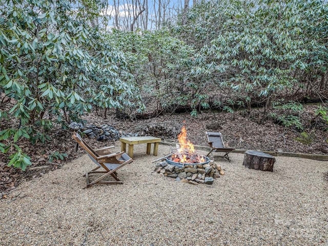 view of yard with a fire pit