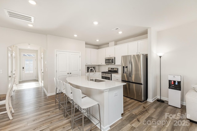 6048 Chelsea Oaks Rdg, Tega Cay, SC 29708 - kitchen featuring stainless steel appliances, a sink, arched walkways, baseboards, and recessed lighting