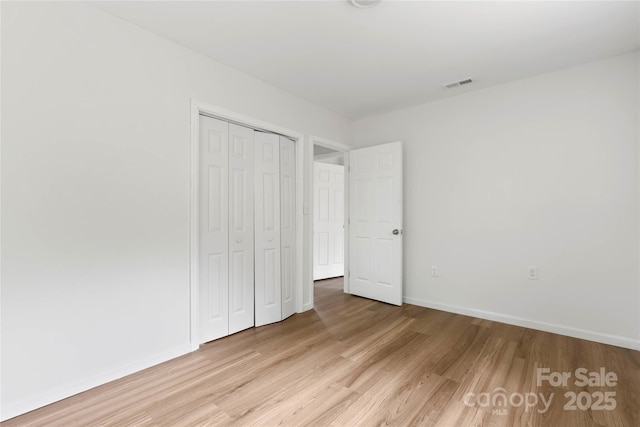 2694 W Lakeshore Dr, Landrum, SC 29356 - unfurnished bedroom featuring light wood-style floors, a closet, and baseboards
