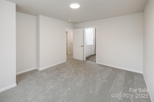 empty room featuring baseboards and carpet floors
