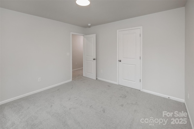 unfurnished bedroom featuring baseboards and carpet flooring