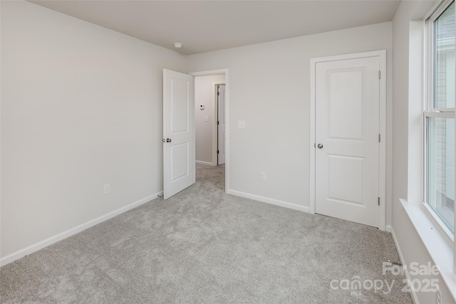 unfurnished bedroom featuring baseboards and carpet floors
