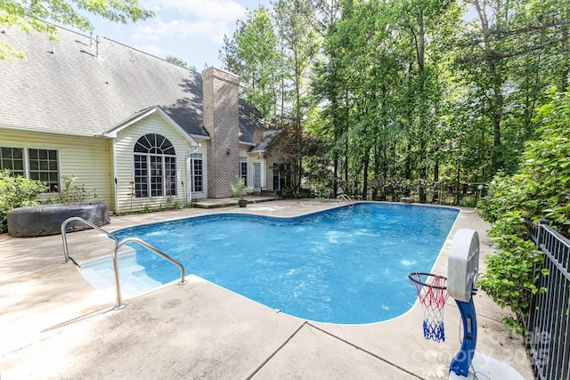 view of swimming pool featuring a patio and a fenced in pool