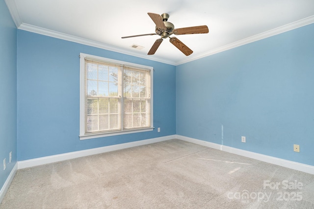 unfurnished room featuring carpet flooring, crown molding, visible vents, and baseboards