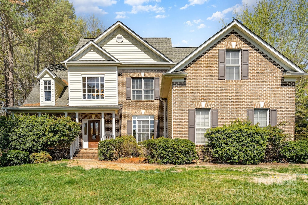 8704 Dartmoor Pl, Mint Hill, NC 28227 - view of front of property with french doors, brick siding, a shingled roof, and a front yard