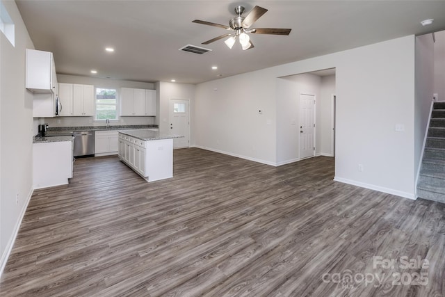 kitchen with a kitchen island, dishwasher, open floor plan, visible vents, and ceiling fan