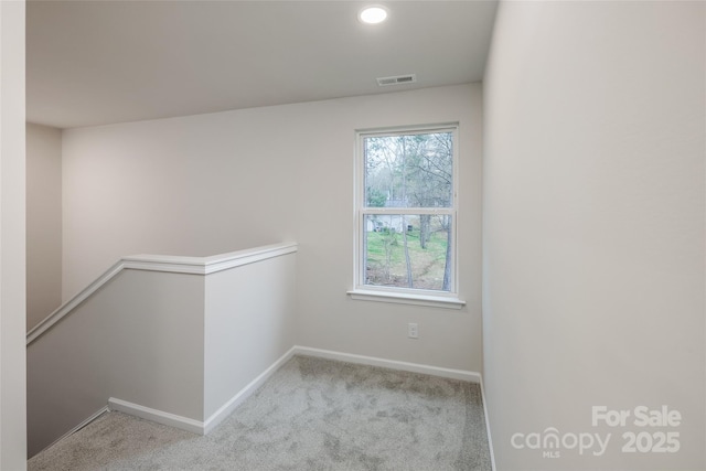 carpeted spare room with baseboards, visible vents, and recessed lighting