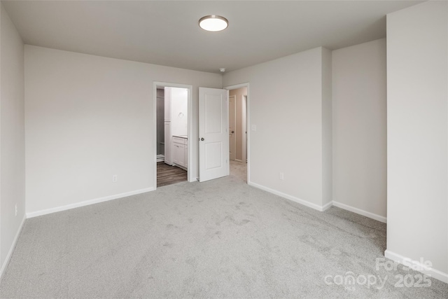 spare room featuring baseboards and carpet