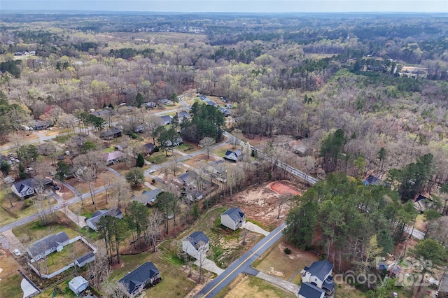 birds eye view of property with a forest view