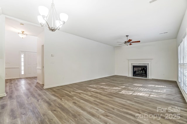 10434 Henbane Ct, Charlotte, NC 28213 - unfurnished living room featuring a high end fireplace, visible vents, baseboards, ceiling fan with notable chandelier, and wood finished floors