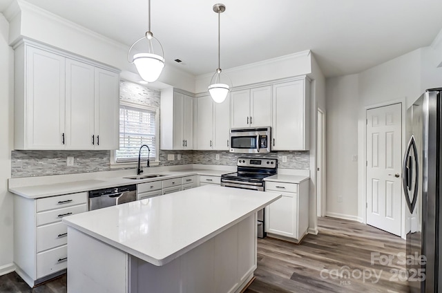 10434 Henbane Ct, Charlotte, NC 28213 - kitchen featuring appliances with stainless steel finishes, white cabinetry, light countertops, and a sink