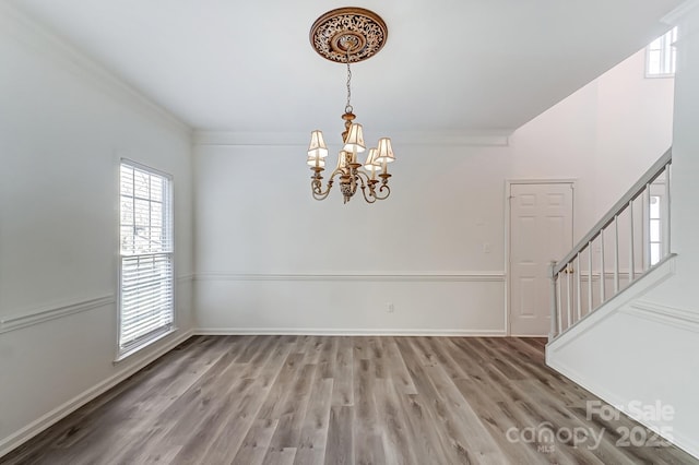 10434 Henbane Ct, Charlotte, NC 28213 - interior space featuring light wood finished floors, stairway, baseboards, and an inviting chandelier