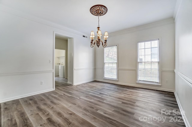 10434 Henbane Ct, Charlotte, NC 28213 - spare room featuring wood finished floors, visible vents, baseboards, an inviting chandelier, and crown molding