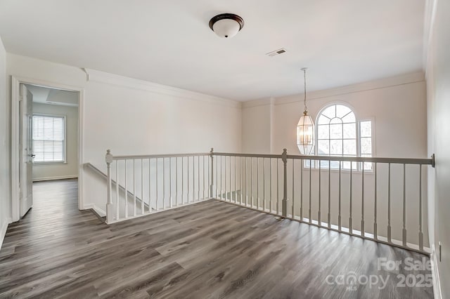 10434 Henbane Ct, Charlotte, NC 28213 - unfurnished room with visible vents, baseboards, wood finished floors, and ornamental molding