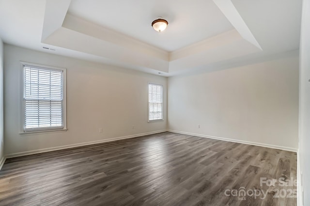 10434 Henbane Ct, Charlotte, NC 28213 - empty room with dark wood-style floors, a raised ceiling, and baseboards