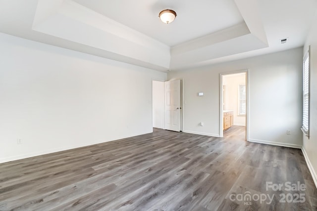 10434 Henbane Ct, Charlotte, NC 28213 - unfurnished room featuring visible vents, a raised ceiling, baseboards, and wood finished floors