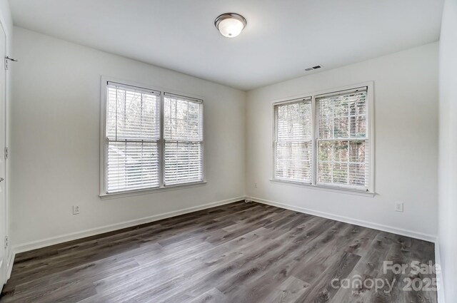 10434 Henbane Ct, Charlotte, NC 28213 - unfurnished room with visible vents, dark wood-type flooring, and baseboards