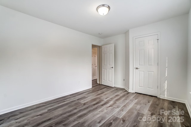 10434 Henbane Ct, Charlotte, NC 28213 - unfurnished bedroom featuring wood finished floors and baseboards