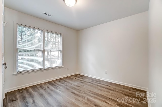 10434 Henbane Ct, Charlotte, NC 28213 - empty room featuring visible vents, wood finished floors, and baseboards