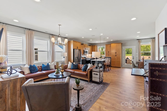 411 Sunharvest Ln, Indian Trail, NC 28079 - living room featuring an inviting chandelier, recessed lighting, and light wood-style floors