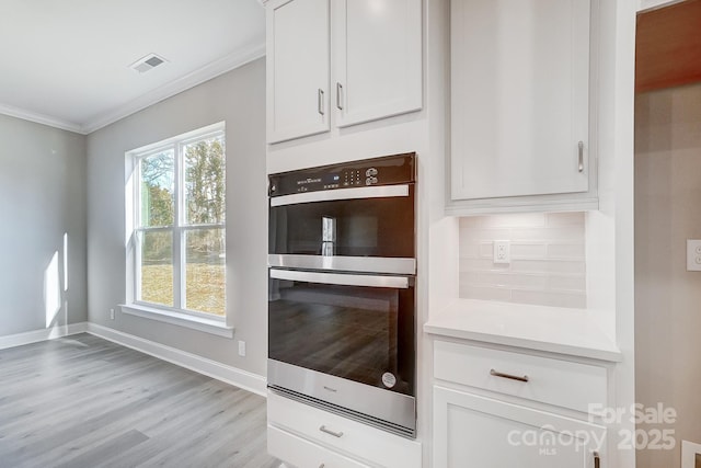 522 Fern Hill Rd Unit 17, Mooresville, NC 28117 - kitchen featuring baseboards, crown molding, double oven, white cabinetry, and light wood-style flooring