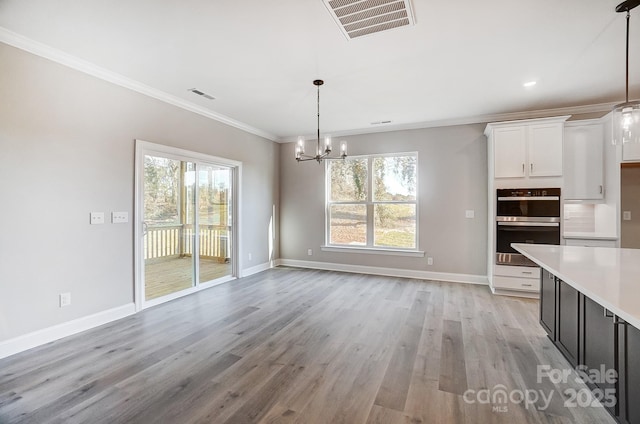 522 Fern Hill Rd Unit 17, Mooresville, NC 28117 - unfurnished dining area with ornamental molding, visible vents, a wealth of natural light, and a chandelier