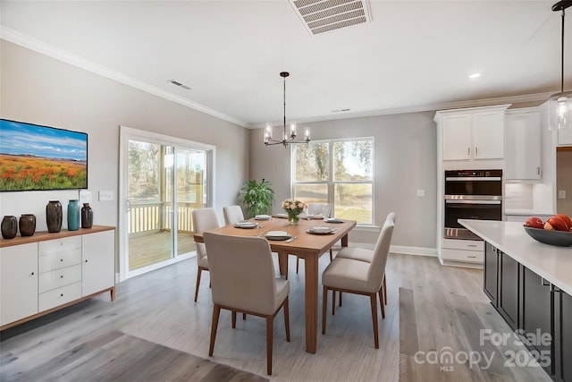 522 Fern Hill Rd Unit 17, Mooresville, NC 28117 - dining area with crown molding, light wood-type flooring, visible vents, a chandelier, and a healthy amount of sunlight