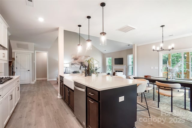522 Fern Hill Rd Unit 17, Mooresville, NC 28117 - kitchen featuring stainless steel appliances, white cabinetry, a kitchen bar, light countertops, and vaulted ceiling
