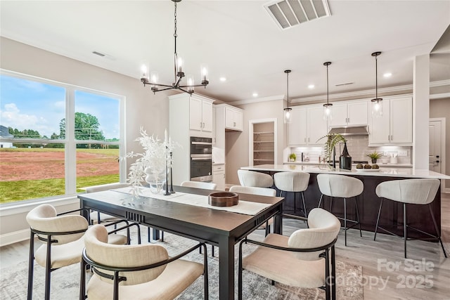 522 Fern Hill Rd Unit 17, Mooresville, NC 28117 - dining area with light wood finished floors, a chandelier, plenty of natural light, recessed lighting, and ornamental molding