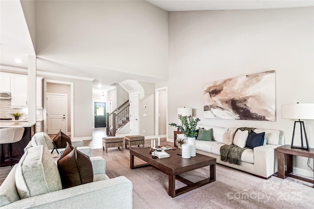 522 Fern Hill Rd Unit 17, Mooresville, NC 28117 - living area with a towering ceiling, stairs, ornate columns, and light wood-style floors