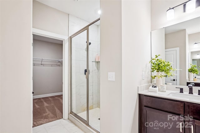 522 Fern Hill Rd Unit 17, Mooresville, NC 28117 - bathroom featuring a spacious closet, marble finish floors, a stall shower, and vanity