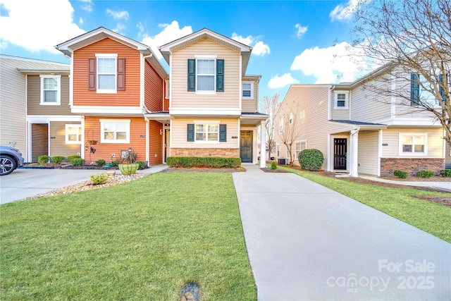 746 Elders Story Rd, Fort Mill, SC 29708 - view of front of house featuring central air condition unit, a front yard, stone siding, and driveway