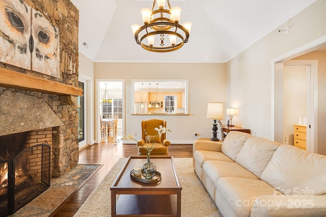 315 Jocassee Trl, Sapphire, NC 28774 - living area with baseboards, a chandelier, vaulted ceiling, a stone fireplace, and wood finished floors