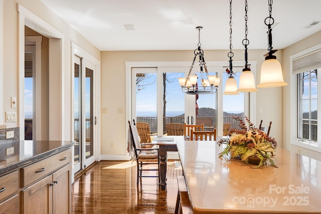 315 Jocassee Trl, Sapphire, NC 28774 - dining room featuring a notable chandelier, visible vents, baseboards, and dark wood-style floors
