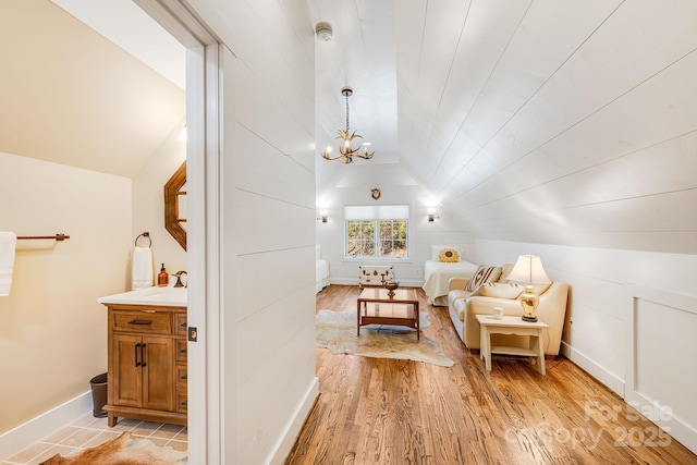 315 Jocassee Trl, Sapphire, NC 28774 - interior space with an inviting chandelier, baseboards, light wood-type flooring, and lofted ceiling