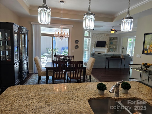 1112 Avalon Pl, Stallings, NC 28104 - dining room with a chandelier, a tray ceiling, a ceiling fan, dark wood-style floors, and ornamental molding