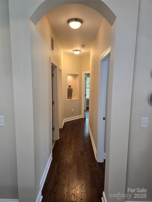 1112 Avalon Pl, Stallings, NC 28104 - hall featuring dark wood finished floors, arched walkways, and baseboards