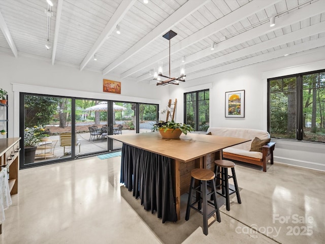dining room featuring wooden ceiling, a notable chandelier, beamed ceiling, concrete flooring, and track lighting