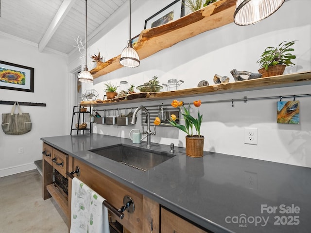 bar featuring a sink, vaulted ceiling with beams, baseboards, concrete flooring, and indoor wet bar