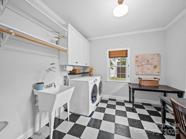 clothes washing area featuring washing machine and clothes dryer, crown molding, cabinet space, dark floors, and baseboards