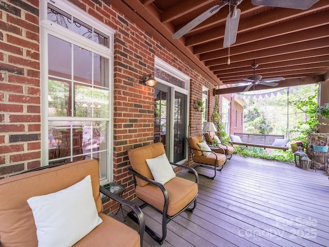 wooden terrace featuring ceiling fan and covered porch