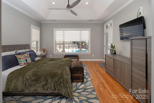 bedroom featuring baseboards, recessed lighting, a ceiling fan, a raised ceiling, and light wood-style floors