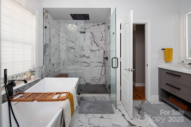 bathroom with vanity, a marble finish shower, a soaking tub, marble finish floor, and baseboards