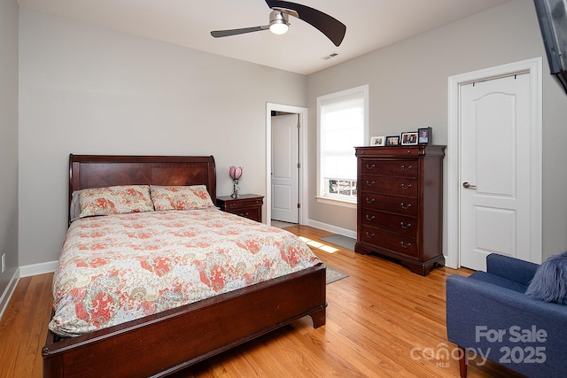 bedroom with light wood-style flooring, baseboards, and visible vents